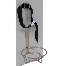 The Novocal oxygen cylinder holder (height: 330 mm, width: 140 mm) features a metal ring and a vertical strap with buckle, ideal for securing cylinders like oxygen tanks or fire extinguishers in medical facilities. Package: 1 piece.