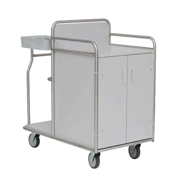 The Novocal station trolley features a robust, fully welded stainless steel frame, four wheels, a white two-door cabinet, a flat plate with side shelf, and a sturdy metal railing - ideal for medical use.