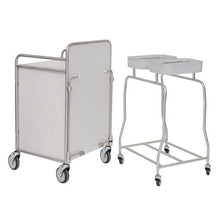 A Novocal shelving basic unit made of precision-nickel-plated, high-gloss chrome steel with 4 corner posts stands next to a two-bin hamper, both ideal for durable storage in healthcare or laundry operations.