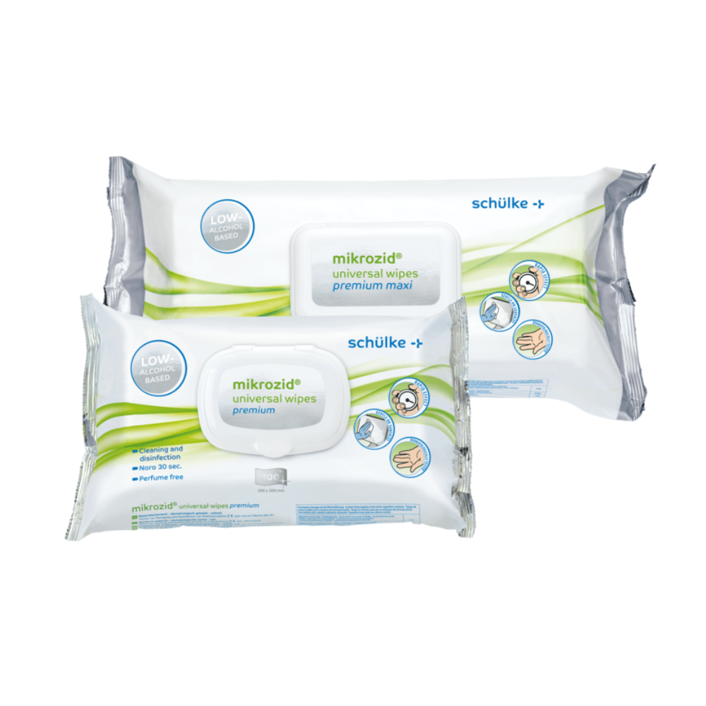 Displayed are two packs of Schülke Mikrozid® universal wipes premium disinfection wipes from Schülke & Mayr GmbH. One is labeled "premium maxi," the other just "premium." Both are predominantly white-green in design, with instructions and symbols for use on the packaging for quick disinfection with alcoholic disinfectant wipes.