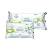 Displayed are two packs of Schülke Mikrozid® universal wipes premium disinfection wipes from Schülke & Mayr GmbH. One is labeled "premium maxi," the other just "premium." Both are predominantly white-green in design, with instructions and symbols for use on the packaging for quick disinfection with alcoholic disinfectant wipes.
