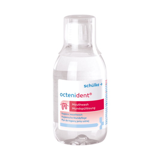 A transparent bottle of Octenident® mouthwash from Schülke & Mayr GmbH with a white label, featuring the product name and a pink logo on a white background. The text on the label contains usage instructions in multiple languages.