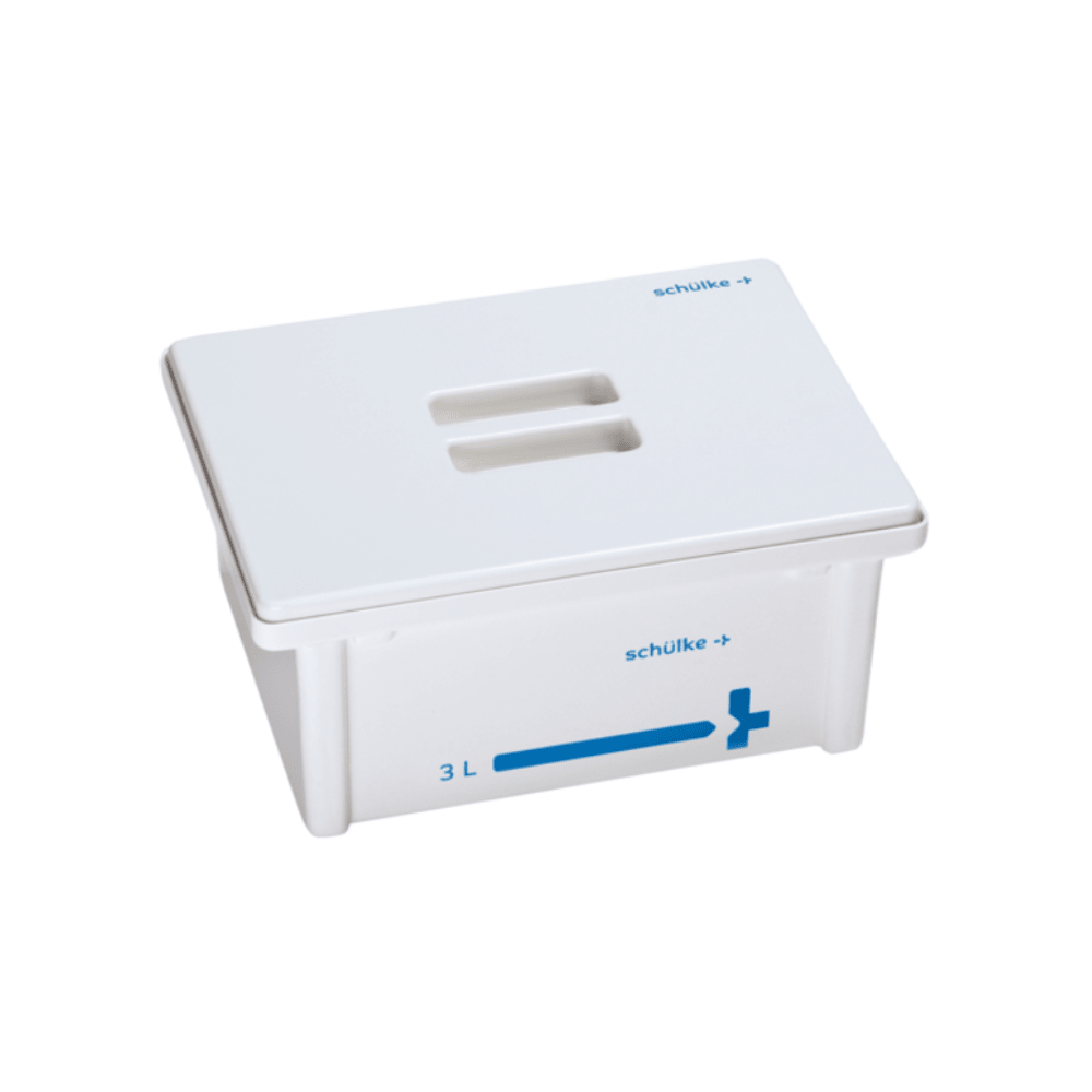 The Schülke Tub System 3 Liters, manufactured by Schülke & Mayr GmbH, is a white plastic container with a lid, which bears the "Schülke +" logo both on the lid and on the side. This container, designed for instrument preparation, has a blue line indicating its capacity of 3 liters. The lid features two rectangular slots for easy opening.