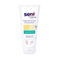 A white tube of Seni Care nourishing balm for dry skin (200 ml) from TZMO Deutschland GmbH with cocoa and shea butter, green “vegan” label, illustrated instructions below – provides intensive moisture for dry skin.