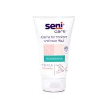 A 100 ml tube of Seni Care Cream from TZMO Deutschland GmbH for dry and rough skin has a white background with light pink and green accents. The label indicates 10% urea, is fragrance-free, increases moisture content, and includes a German instruction.