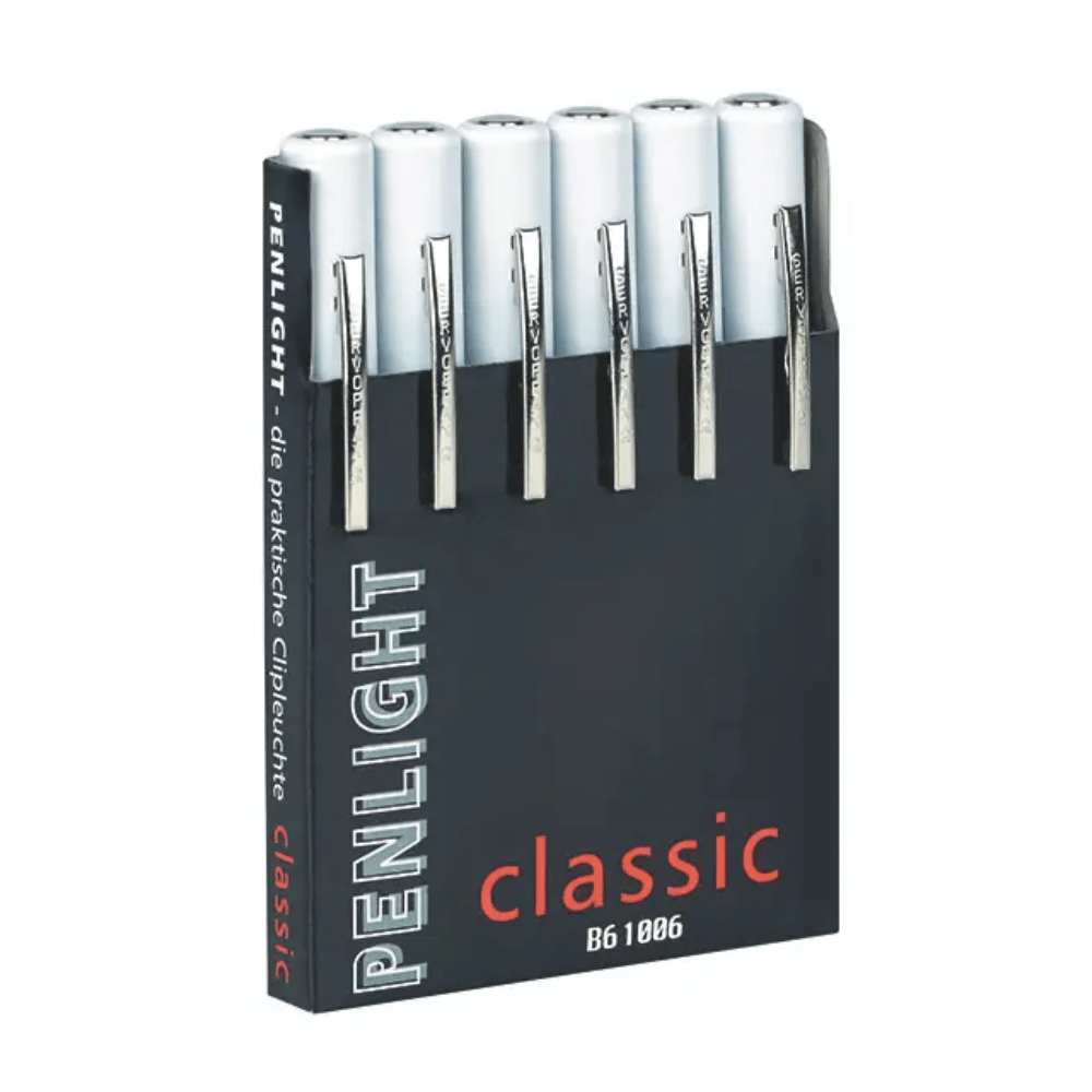 A black box labeled “Penlight Classic Six Pack Dispenser, printed” by Servoprax GmbH contains six white, pen-shaped flashlights, commonly used in medical examinations. Each penlight has a silver clip for convenient access during diagnosis.