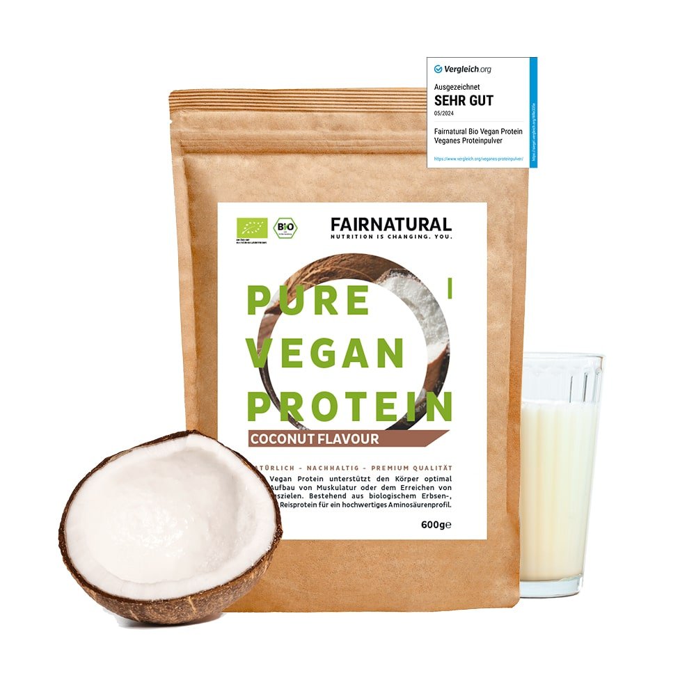A brown resealable 600g bag of Fairnatural® Organic Vegan Protein Powder Coconut without Soy stands upright next to a halved coconut and a glass of coconut milk - ideal for diet or muscle building as a delicious vegan protein shake.