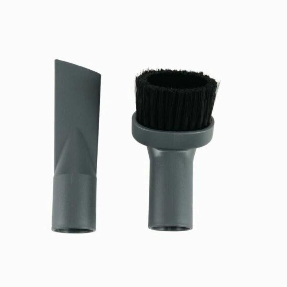 On a white background, two vacuum cleaner attachments from Diversey Deutschland GmbH & Co. OHG are depicted. On the left, a narrow crevice nozzle, on the right, a round brush nozzle with bristles. Both accessories are designed for the TASKI AERO, are gray in color, and are included with all AERO 15 models.