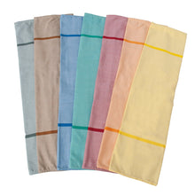 Six folded cloth napkins in gray, taupe, blue, petrol, pink, and yellow with a stripe are arranged on a white background next to the Novocal textile laundry bag self-opening (100% polyester, approx. 12 kg capacity) by Novocal.