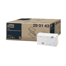 A box of Tork 290143 soft zigzag towels Advanced H3 2-ply is displayed next to an open package with a leaf design. The box with the model number 29 01 43 features a blue-beige color scheme that ideally matches the Advanced H3 Tork dispenser setup.