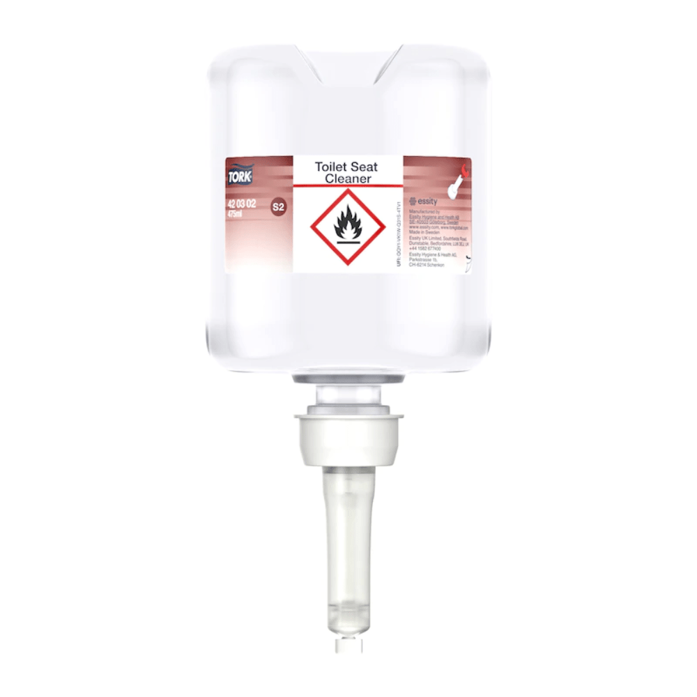 The Tork 420302 Toilet Seat Cleaner Premium, delivered in a carton with eight bottles and manufactured by TORK – Essity Professional Hygiene Germany GmbH, promotes hygiene by preventing cross-contaminations. The transparent dispenser bottle includes instructions and features a bottom nozzle for easy application. Additionally, it is marked with a warning symbol for flammable substances for safety reasons.
