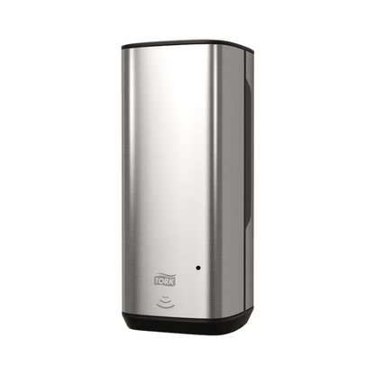We present the Tork 460009 Skincare Dispenser, a sophisticated automatic soap dispenser with a stainless steel look and black accents. It is equipped with an Intuition Sensor for touch-free convenience and displays the wave symbol to highlight hands-free operation. This elegant stainless steel design with the brand name "TORK" from Essity Professional Hygiene Germany GmbH on the front enhances any environment.