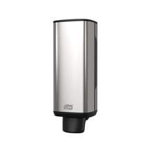The Tork 460010 dispenser for soap and hand sanitizers from TORK – Essity Professional Hygiene Germany GmbH features a sleek, rectangular stainless steel design with a refined black nozzle at the bottom and the "Tork" logo near the base. Its modern aesthetic stands out beautifully against a white background, making it perfect for dispensing soap and hand sanitizers.