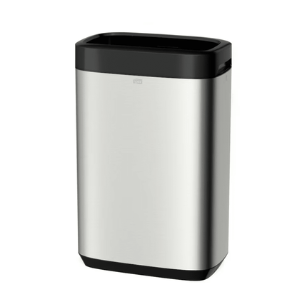 The Tork 460011 Tork Waste Bin Image Line, presented by TORK – Essity Professional Hygiene Germany GmbH, is a sleek and minimalist rectangular trash can made of stainless steel with a black lid and base. Its stainless steel design offers a considerable capacity of 50 liters, combining style with functionality and features a small handle for easy opening.