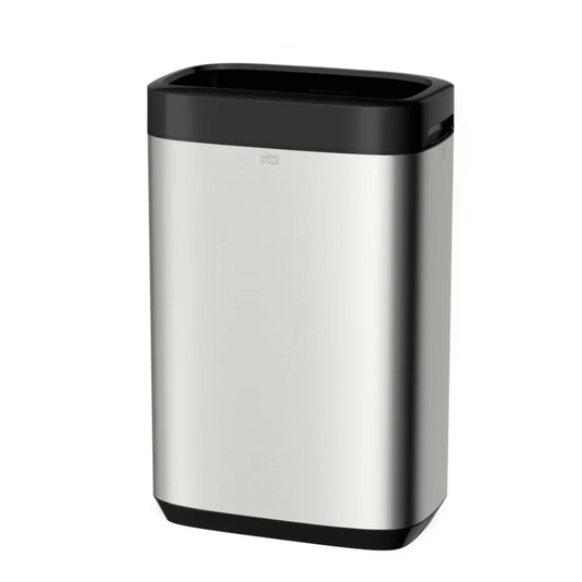The Tork 460011 Tork Waste Bin Image Line, presented by TORK – Essity Professional Hygiene Germany GmbH, is a sleek and minimalist rectangular trash can made of stainless steel with a black lid and base. Its stainless steel design offers a considerable capacity of 50 liters, combining style with functionality and features a small handle for easy opening.