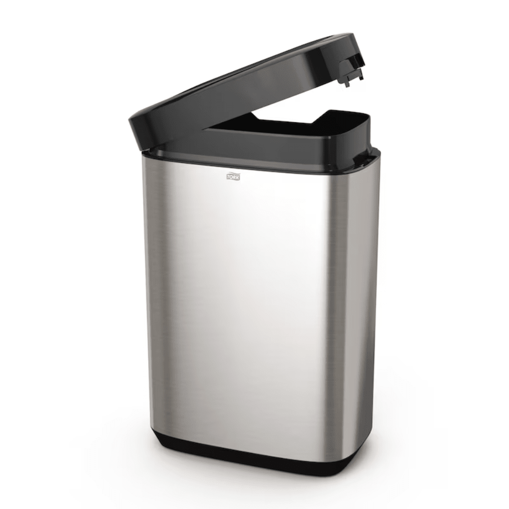 The Tork 460011 Tork Waste Bin from the Image Line series by TORK – Essity Professional Hygiene Germany GmbH features a slightly open stainless steel design with a black sensor-activated lid. Its sleek stainless steel design offers a capacity of 50 liters and a rectangular shape with a smooth surface, ideal for modern spaces.