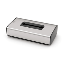 The Tork 460013 dispenser for cosmetic tissues from the Image Line F1 collection by TORK – Essity Professional Hygiene Germany GmbH is a tissue box made of stainless steel with a rectangular slot at the top. It presents itself in a stainless steel design, has black lacquered edges, and a minimalist style that is ideal for single sheet dispensing.
