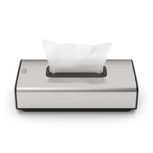 We present the Tork 460013 dispenser for cosmetic tissues Image Line F1 from Essity Professional Hygiene Germany GmbH. This elegant silver tissue dispenser features a modern rectangular design with a stainless steel design finish. It has a single sheet dispensing function, allowing a white tissue to be partially pulled out from the top opening, and its minimalist appearance makes it ideal for cosmetic tissues.