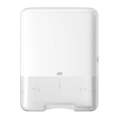 The Tork 553000 dispenser for zigzag towels Elevation H3 from TORK – Essity Professional Hygiene Germany GmbH is a white, wall-mounted paper towel dispenser with a sleek rectangular design and a discreet brand logo at the bottom center. It offers single sheet dispensing for efficient use and features a transparent section at the bottom for easy monitoring of the paper level.