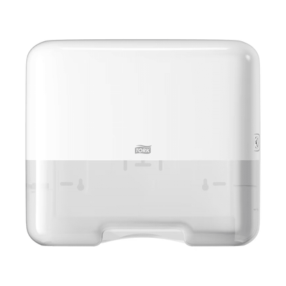 The Tork 553100 Mini Dispenser for Zigzag Hand Towels Elevation H3 by TORK - Essity Professional Hygiene Germany GmbH is a white, rectangular paper towel dispenser with a translucent lower part. It features a small logo in the center and embodies the simple, functional elegance characteristic of the Elevation design. This makes it ideal for the efficient dispensing of zigzag hand towels.