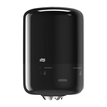 A Tork 559008 Elevation M2 internal roll dispenser with a sleek cylindrical design and the distinctive TORK logo from Essity Professional Hygiene Germany GmbH is mounted on the wall. This black dispenser features a high capacity and efficiently holds white paper towels for easy access.
