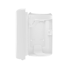 The Tork 563000 Waste Bin Elevation by Essity Professional Hygiene Germany GmbH is a sleek, white plastic housing for wall mounting with a hinged door. Its smooth, rounded shape is versatile and offers various mounting options for housing electronic or communication components in an open and minimalist interior.