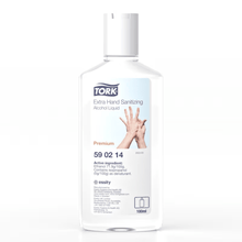 A 100 ml bottle of Tork 590214 Extra Disinfecting Hand Alcohol Liquid has a label that highlights hands and prominently displays ingredients like ethanol. The TORK logo is clearly visible, and a recycling symbol is subtly located at the bottom.