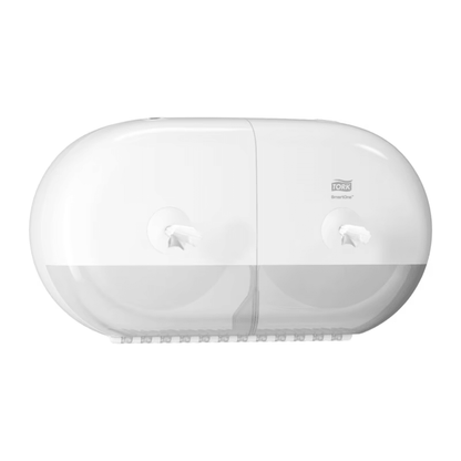 The Tork SmartOne® 682000 Mini Twin Roll Dispenser for Toilet Paper T9 from Essity Professional Hygiene Germany GmbH is a white, wall-mounted twin roll dispenser with a transparent bottom part. The logo is located at the top right, allowing visibility of the two paper rolls through the transparent cover. This design ensures efficient use and helps keep your bathroom tidy and functional.