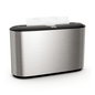 The Tork Xpress® 460005 table dispenser for multifold towels from Essity Professional Hygiene Germany GmbH is characterized by an elegant stainless steel design. Its silver metallic exterior is accented by a black top, with a section of white paper towels elegantly protruding from the top slot. Ideal for users of multifold towels who appreciate both style and functionality.