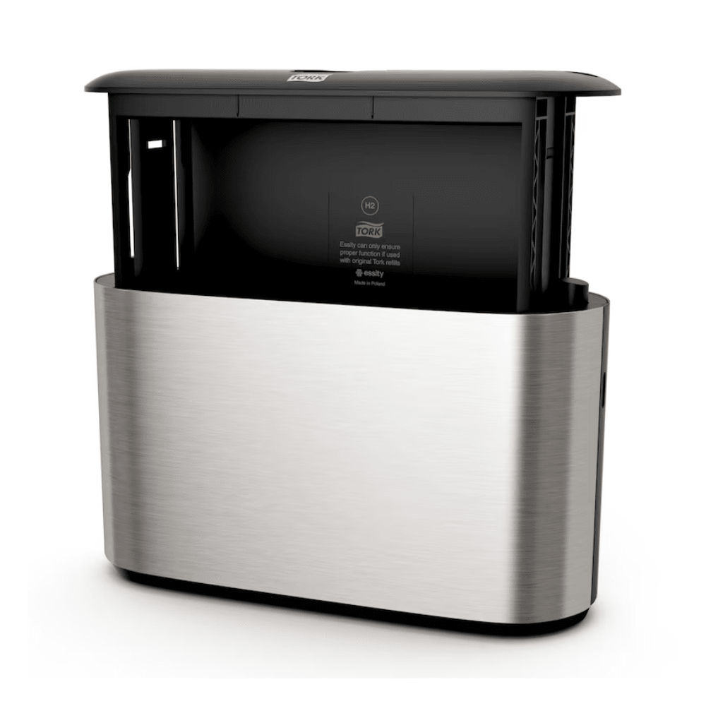We present the Tork Xpress® 460005 table dispenser, a stylish automatic stainless steel dispenser with a modern design, ideal for multifold towels. This product from TORK – Essity Professional Hygiene Germany GmbH features a black top with a visible sensor in the middle and side openings for easy towel dispensing.