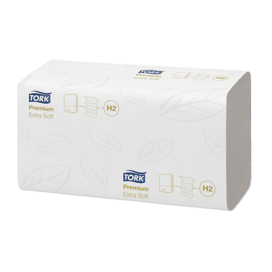 The product shown is a rectangular pack of Tork Xpress® 100297 extra-soft Multifold hand towels (H2) in white packaging with a subtle leaf pattern. The words “Tork Xpress®” and “H2” are printed in blue and gold, reflecting the premium quality of TORK – Essity Professional Hygiene Germany GmbH.