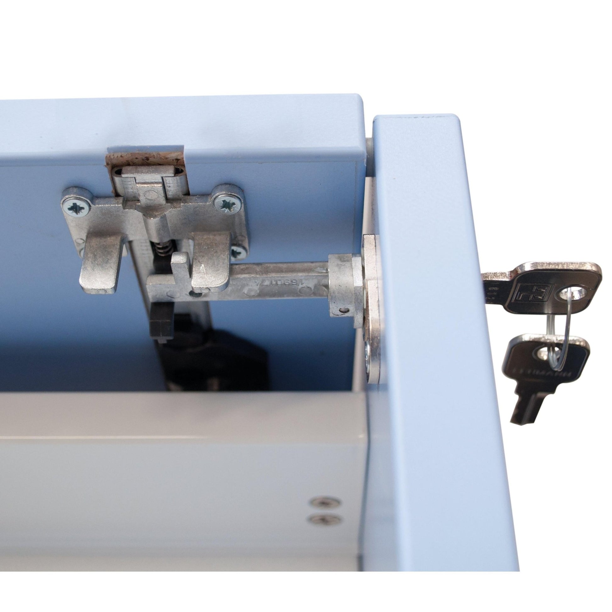 Close-up of a Novocal central lock for all Novocal drawers, with two keys in the lock on a light blue metal drawer. The visible locking bar and hinge make it ideal for securely locking your cabinet.