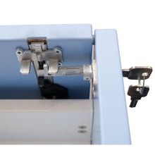 Close-up of a Novocal central lock for all Novocal drawers, with two keys in the lock on a light blue metal drawer. The visible locking bar and hinge make it ideal for securely locking your cabinet.