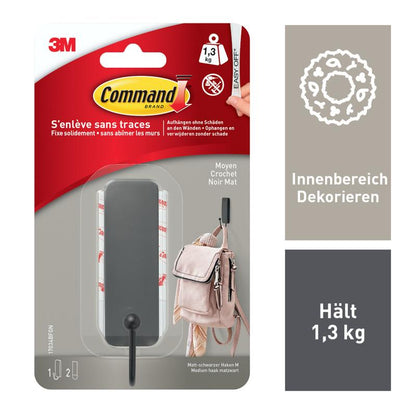 A package from 3M Deutschland GmbH with 1 medium-sized Command™ matte black hook (17034B) and 2 strips; holds up to 1.3 kg, no drilling required. Includes black wall hook, adhesive strips, and a sample image; info in French & German.