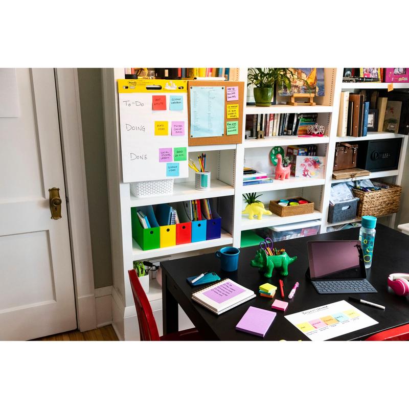 A tidy home office with white shelves, a black desk with notebooks, an iPad, pens, a water bottle, and colorful Post-it® Super Sticky Z-Notes (Boost Collection) from 3M Deutschland GmbH on a flip chart labeled "To-Do, Doing, Done."