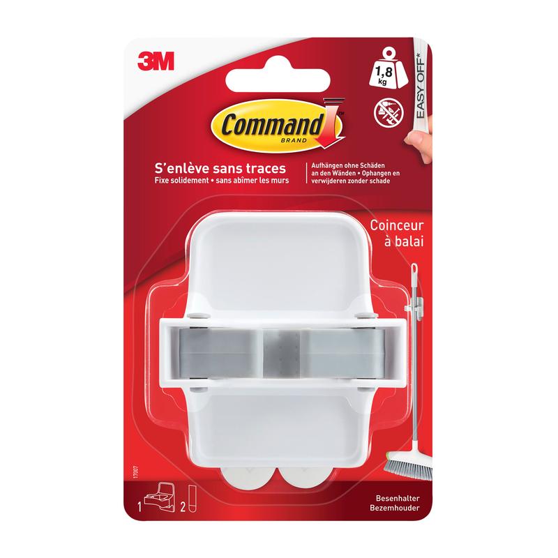 A white Command™ broom holder 17007-FR from 3M Deutschland GmbH in a plastic packaging with a red background, French text, Command adhesive strip branding, and an image of a broom next to the holder.