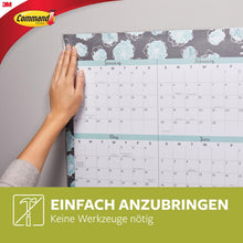 A person hangs a large floral wall calendar with Command™ Poster Strips in the advantage pack, 17024-VP from 3M Deutschland GmbH. The German text reads: "Easy to apply. No tools needed." The 3M Command logo appears.