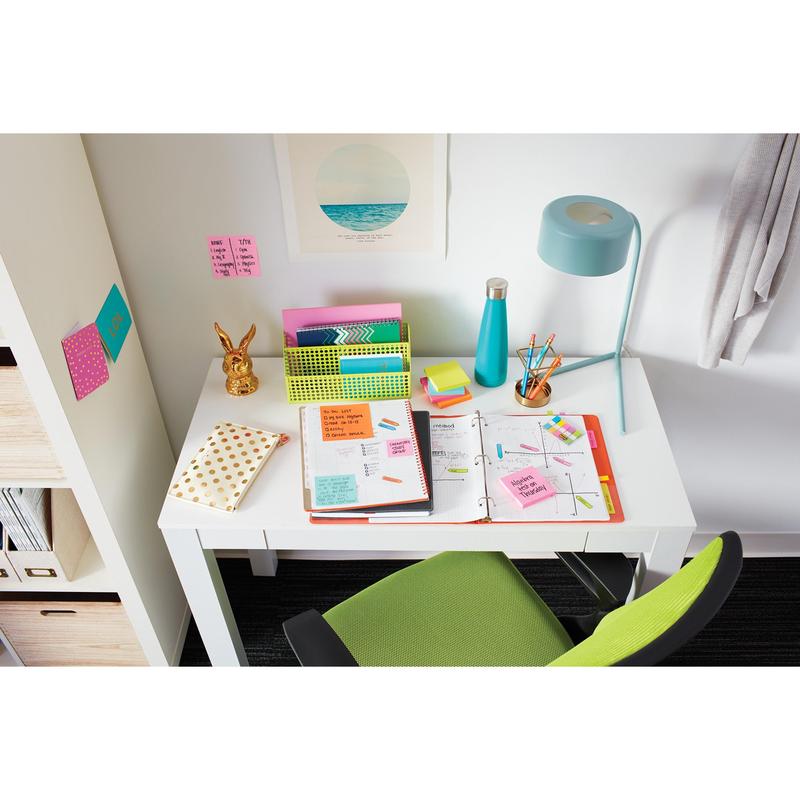 On the white desk, there is an open folder, pens, a blue bottle, a lamp, organizer, a golden rabbit figure, and a green chair. Above the desk, 3M Post-it® Notes from the Poptimistic Collection (38x51 mm) by 3M Deutschland GmbH adorn the wall.