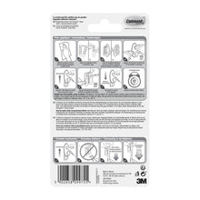 The back of a Command™ Clothes Hook, 17019-FGN package from 3M Deutschland GmbH shows a pictorial step-by-step guide for wall mounting without drilling, warnings, product details, the barcode, and the 3M logo in black and white.