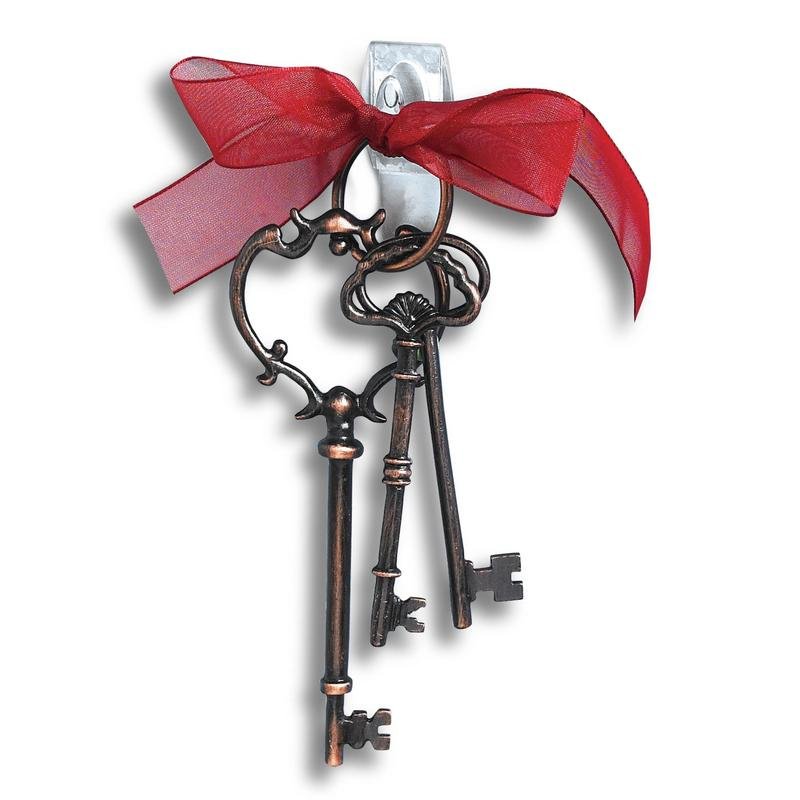 Three ornate, antique-looking keys on a keyring with a red ribbon hang on a white wall with 3M Deutschland GmbH Command™ Mini Hooks, transparent, with transparent strips, 17006CLRFGN-perfect for storage without drilling.