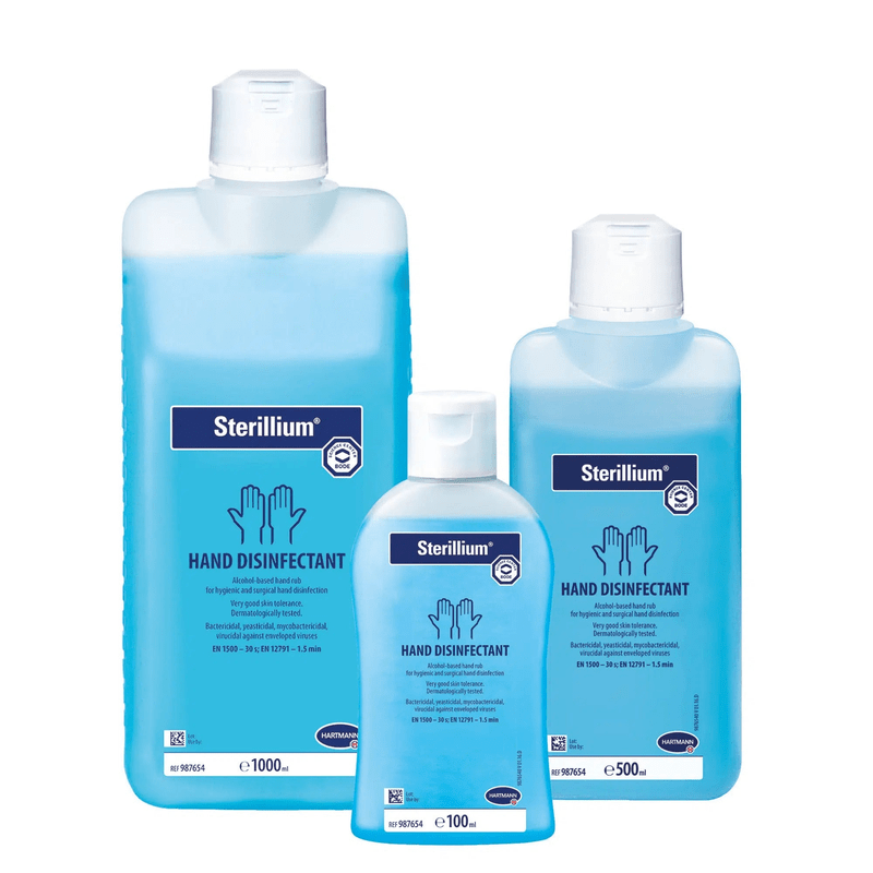 Three bottles of Sterillium® hand disinfectant in different sizes arranged in a row, with blue liquid and labels with product information from Paul Hartmann AG.