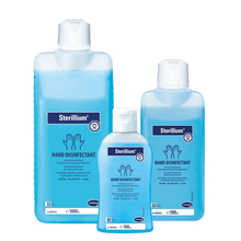 Three bottles of Sterillium® hand disinfectant in different sizes arranged in a row, with blue liquid and labels with product information from Paul Hartmann AG.