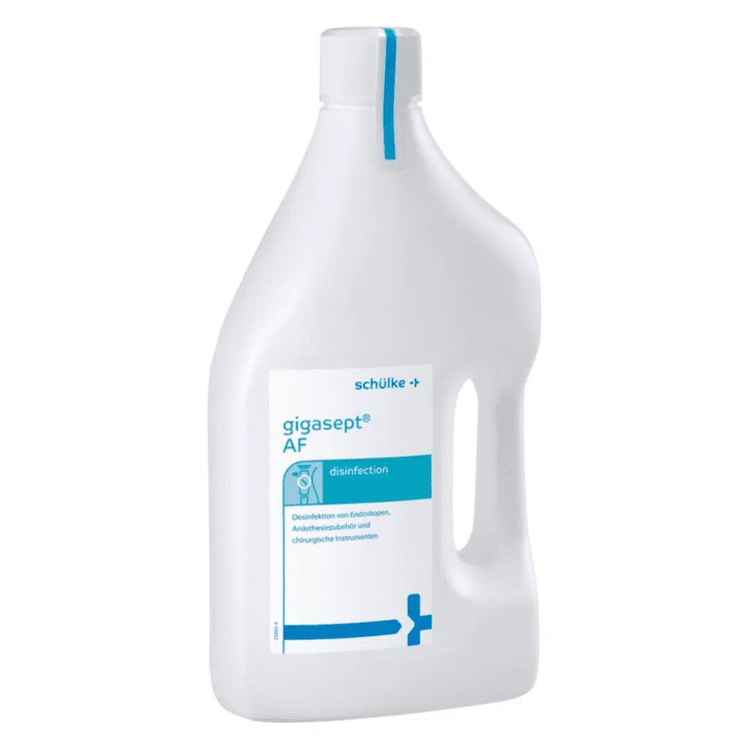 A bottle of Schülke gigasept® instru AF instrument disinfectant (aldehyde-free) from Schülke & Mayr GmbH, white with blue accents, for disinfecting medical instruments including endoscopes. The label contains text and a medical cross.